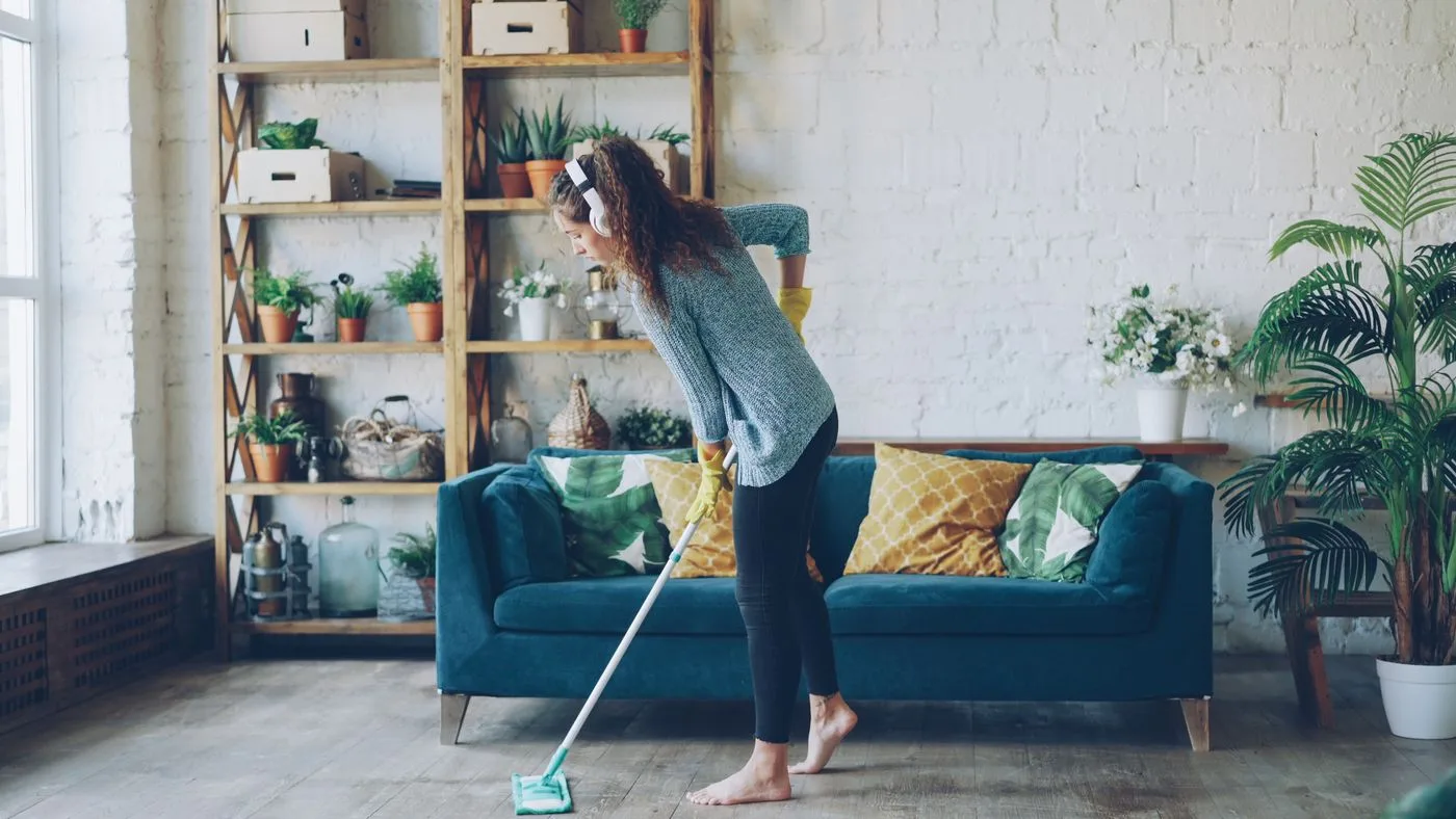 Woman Cleaning Living Room with Mop