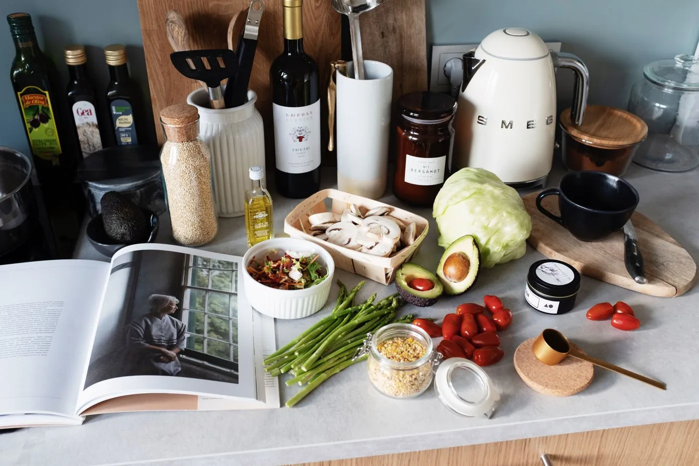 Countertop with utensils and plenty of vegetables
