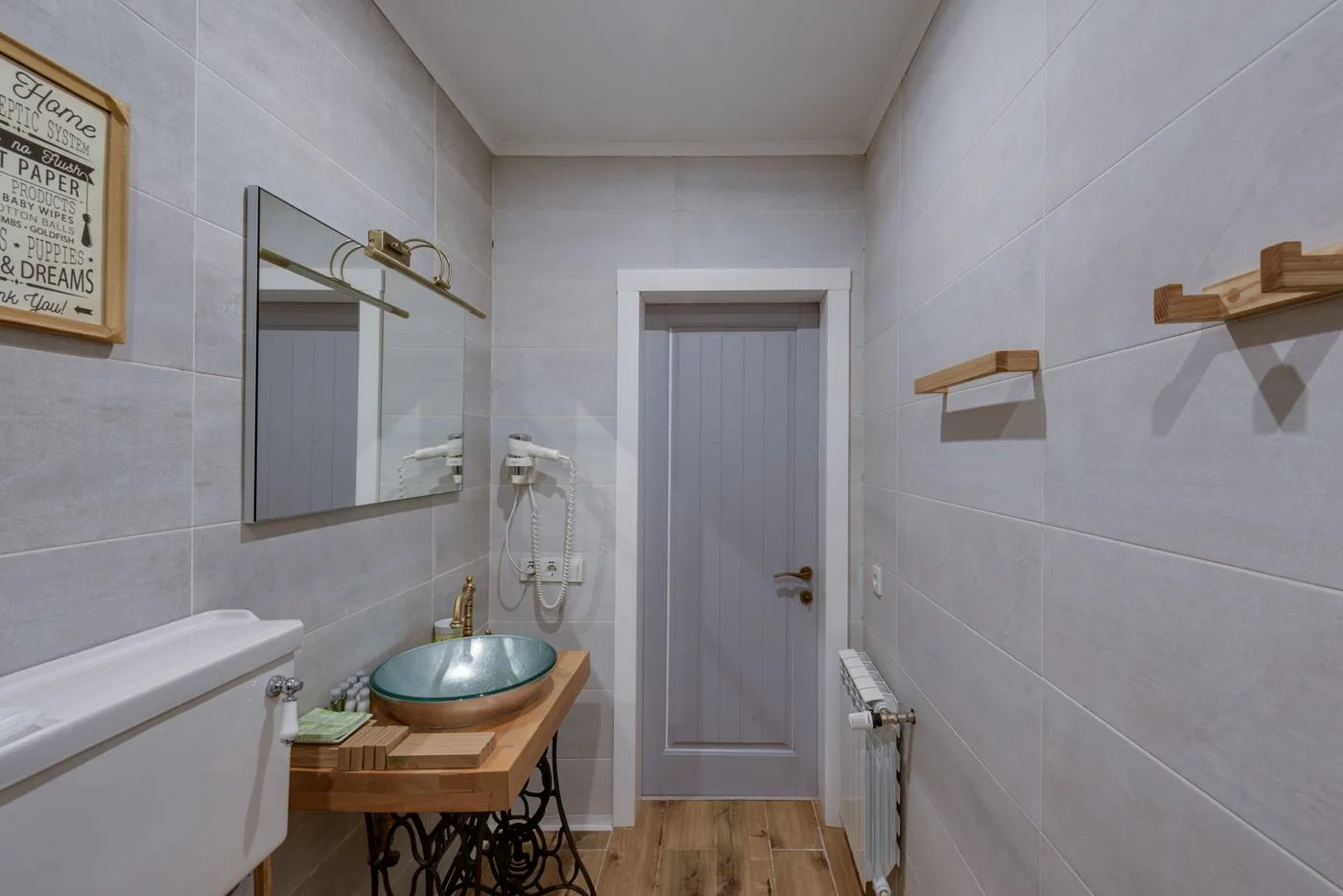 A Gray and White Bathroom with Wooden Countertop and Towel Rack